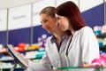 Pharmacist with assistant in pharmacy Royalty Free Stock Photo
