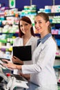 Pharmacist with assistant in pharmacy Royalty Free Stock Photo