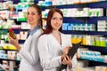 Pharmacist with assistant in pharmacy Royalty Free Stock Photo