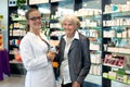 Pharmacist assisting an elderly lady Royalty Free Stock Photo