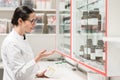 Pharmacist checking a chemical pharmaceutical substance in a modern drugstore