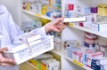 Pharmacist chemist woman standing refills the shelves with new stocks in pharmacy Royalty Free Stock Photo