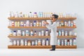 Pharmacist selecting medication in a contemporary drugstore. Healthcare and pharmaceuticals Royalty Free Stock Photo