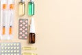 Pharmacist concept. Flat lay composition with vials, syringes and pills on beige background, space for text Royalty Free Stock Photo