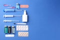 Pharmacist concept. Flat lay composition with vials, syringes and pills on blue background, space for text Royalty Free Stock Photo