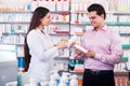 Pharmacist and consulting man in pharmacy Royalty Free Stock Photo