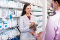 Pharmacist and consulting man in pharmacy Royalty Free Stock Photo