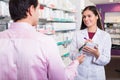 Pharmacist counseling customer about drugs