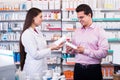 Pharmacist counseling customer about drugs Royalty Free Stock Photo