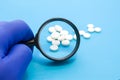 Pharmacist or expert on pharmaceutical inspection identifies pills. Testing, verification and determining pharmaceutical counterfe