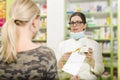 Pharmacist explaining patient how to use medicne Royalty Free Stock Photo