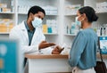 Pharmacist, face mask or black man giving pills to woman patient in customer service for wellness advice. Healthcare Royalty Free Stock Photo