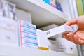 pharmacist hand holding medicine box in drugstore