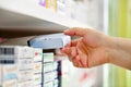 Pharmacist hand holding medicine box in pharmacy