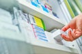 Pharmacist hand holding medicine box in pharmacy