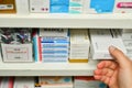 Pharmacist hand holding medicine box in pharmacy