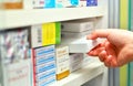 Pharmacist hand holding medicine box in pharmacy