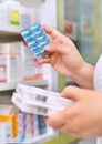 Pharmacist holding medicine box and capsule pack Royalty Free Stock Photo