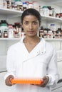 Pharmacist Holding Tray Of Test Tubes