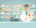 Pharmacist man with medicine at counter in pharmacy