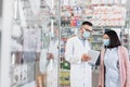 Pharmacist in medical mask holding digital