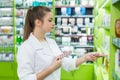 Pharmacist offering some blistered pills in drugstore