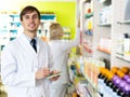 Pharmacist and pharmacy technician posing in drugstore Royalty Free Stock Photo