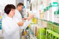 Pharmacist and pharmacy technician posing in drugstore Royalty Free Stock Photo