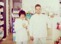 Pharmacist and pharmacy technician posing in drugstore Royalty Free Stock Photo