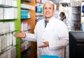 Pharmacist and pharmacy technician posing in modern farmacy