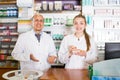 Pharmacist and pharmacy technician posing in modern farmacy Royalty Free Stock Photo