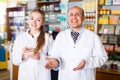 Pharmacist and pharmacy technician posing in modern farmacy Royalty Free Stock Photo