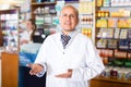 Pharmacist and pharmacy technician posing in modern farmacy