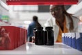 Pharmacist putting medication bottles on drugstore shelf, close up Royalty Free Stock Photo