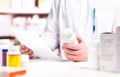 Pharmacist reading prescription with medicine and pill bottle