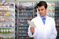 Pharmacist reading prescription at pharmacy Royalty Free Stock Photo