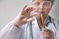 Pharmacist, scientist, doctor holds a comb and removes hair for a test of biological material for DNA, pathology, blue virtual