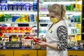 A pharmacist sells medicines to a patient in a pharmacy.