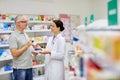 Pharmacist and senior man buying drug at pharmacy Royalty Free Stock Photo