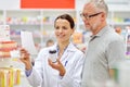 Pharmacist and senior man buying drug at pharmacy Royalty Free Stock Photo