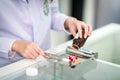 Pharmacist separate and count medicine capsule in steel tray by hand Royalty Free Stock Photo