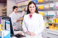 Pharmacist standing at pay desk Royalty Free Stock Photo