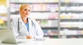 Pharmacist using laptop computer at pharmacy. Royalty Free Stock Photo