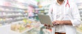 Pharmacist using laptop computer at pharmacy. Royalty Free Stock Photo