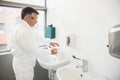 Pharmacist washing his hands at sink Royalty Free Stock Photo
