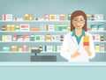 Pharmacist woman with medicine at counter in pharmacy