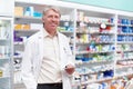 Pharmacist at work. Portrait of mature pharmacist holding a prescription in drugstore. Royalty Free Stock Photo