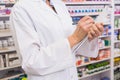 Pharmacist writing prescription on clipboard Royalty Free Stock Photo