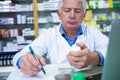 Pharmacist writing prescriptions for medicines Royalty Free Stock Photo