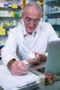 Pharmacist writing prescriptions for medicines Royalty Free Stock Photo